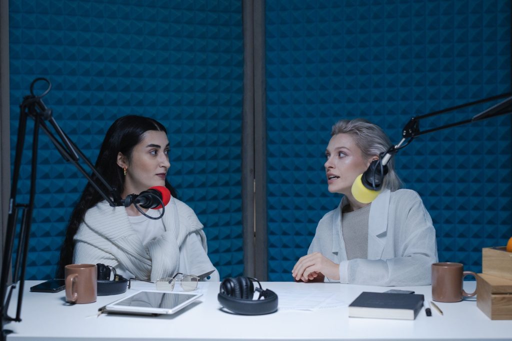 women having conversation inside the studio while looking at each other
