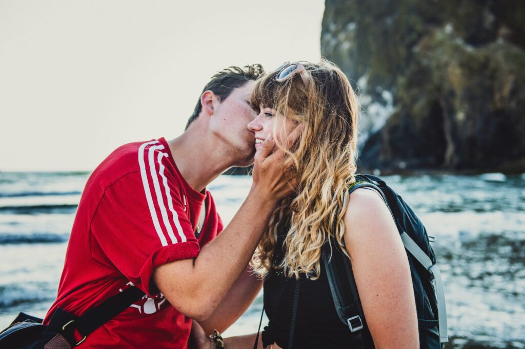 photo of man kissing woman