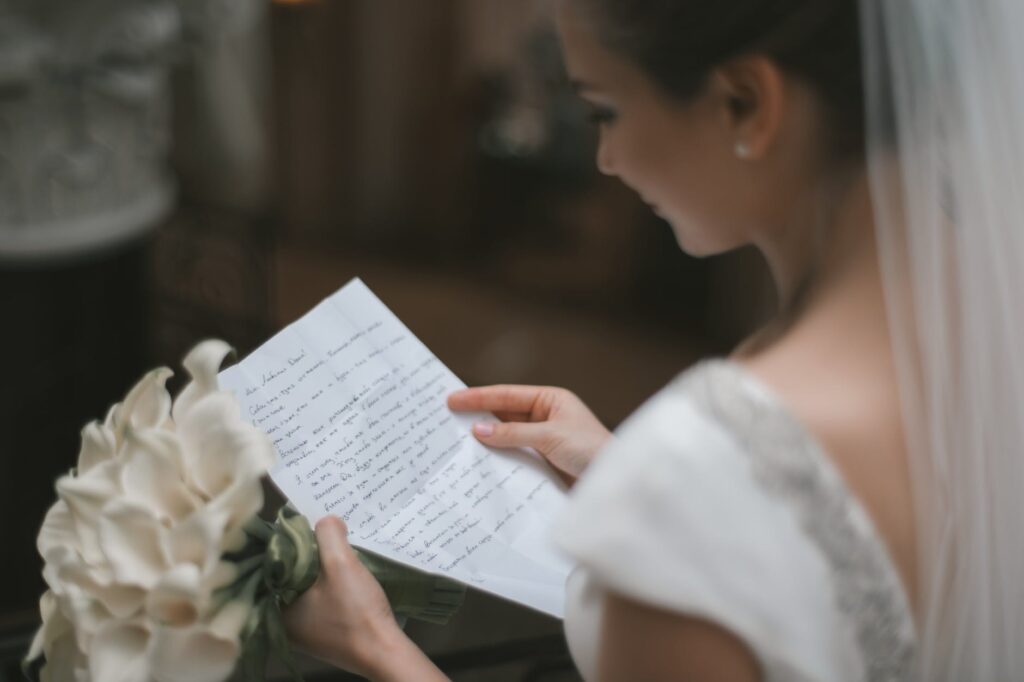 bride with bouquet and wedding vow in hands