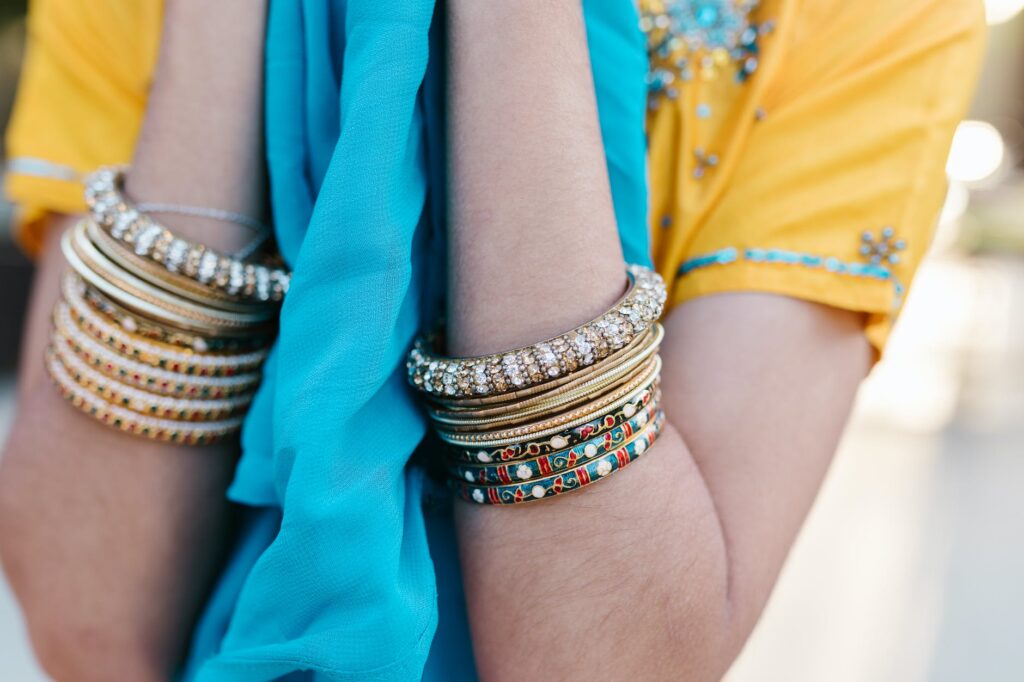 person wearing gold and silver bracelets
