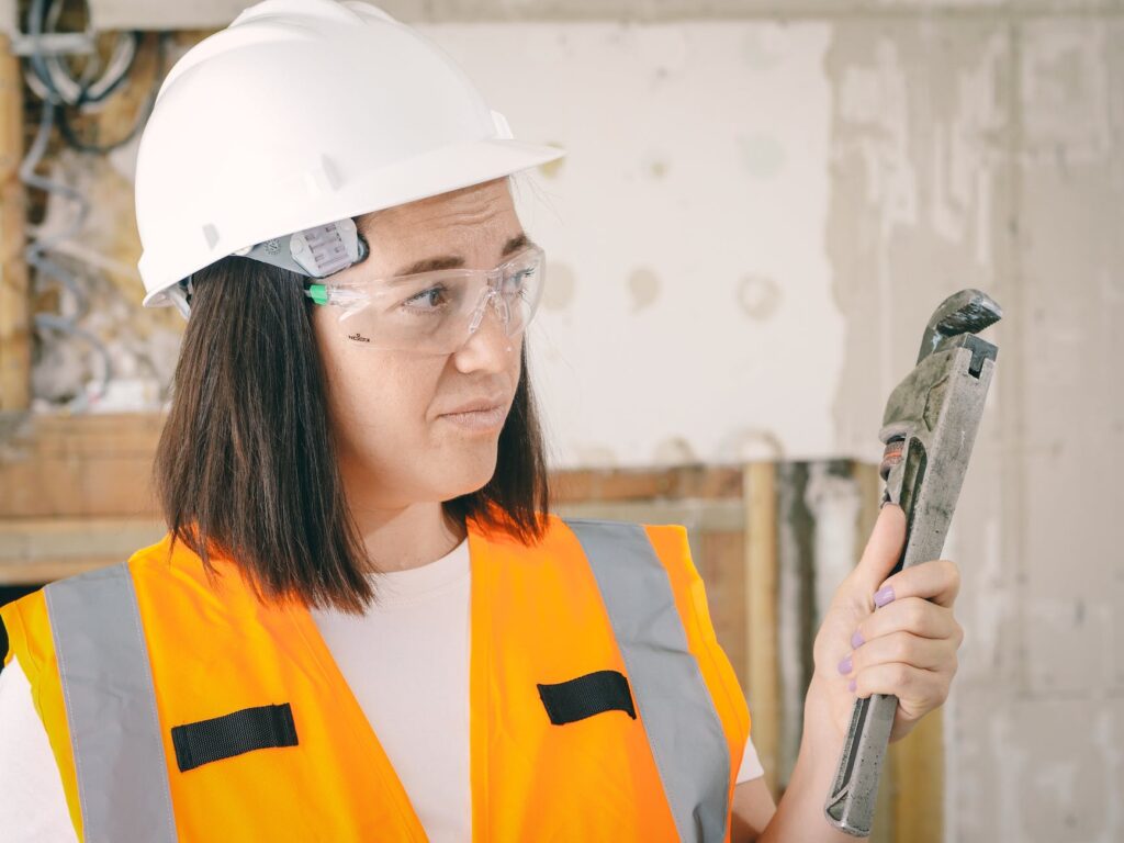handywoman holding a plumbers wrench