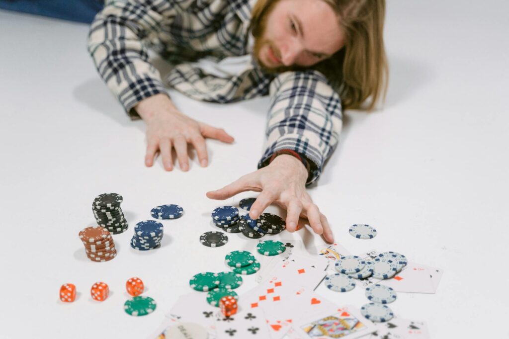 man reaching for poker chips