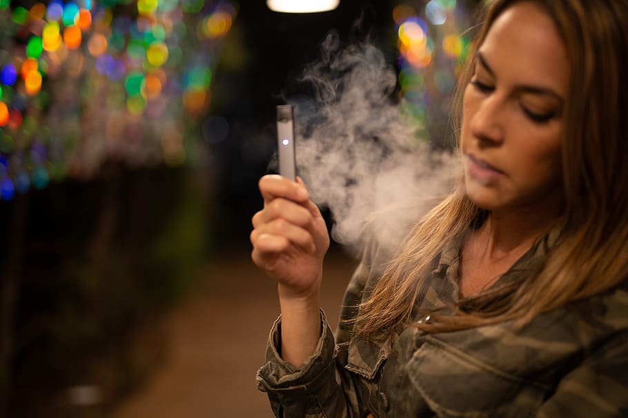 Lady using Vape Cartridge Outdoor